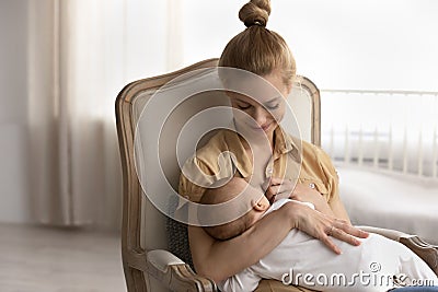 Smiling young mother breastfeed newborn baby child Stock Photo