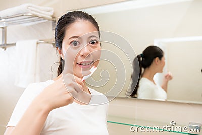 Young mother holding toothbrush face to camera Stock Photo