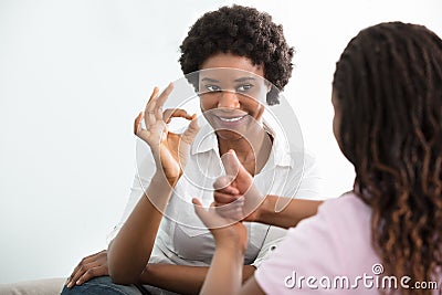 Deaf Mother Talking Sign Language With Her Daughter Stock Photo