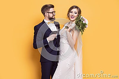 Smiling young newly married on a yellow background Stock Photo
