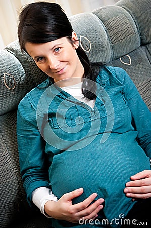 Smiling young pregnant woman Stock Photo