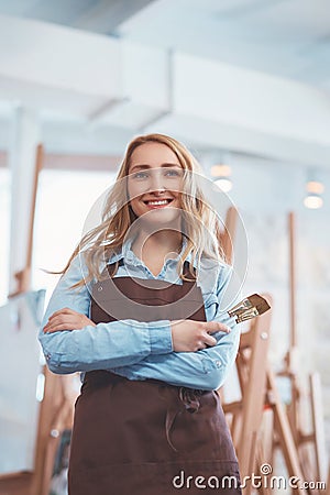 Young seller in uniform in the art store Stock Photo
