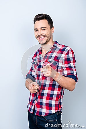 Smiling young stylish bearded brunet student in bright casual ch Stock Photo