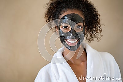 Smiling woman with charcoal face mud Stock Photo