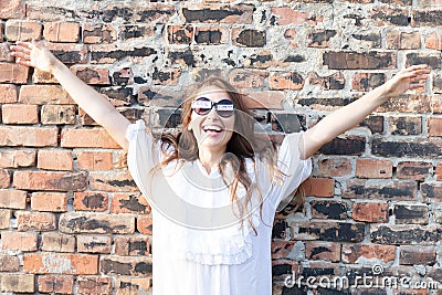 Smiling young woman with freedom sign on sunglasses Stock Photo
