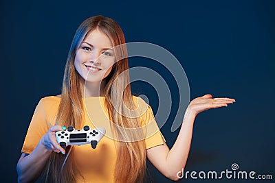 Smiling young woman holding joystick looking at camera Stock Photo