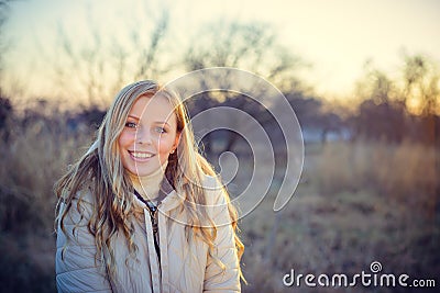 Smiling young woman looking at the camera with blue eyes Stock Photo