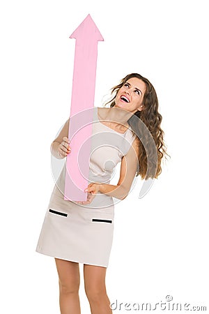 Smiling young woman pointing up on copy space Stock Photo