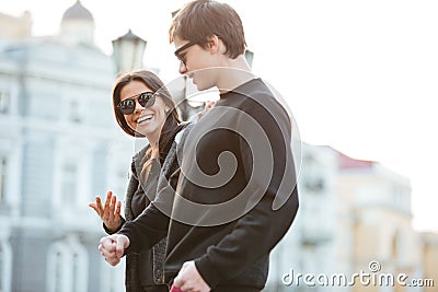 Smiling young woman walking outdoors with her brother. Stock Photo