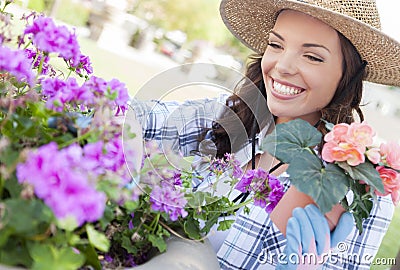 Smiling Young Woman Wearing Hat Gardening Outdoors Stock Photo