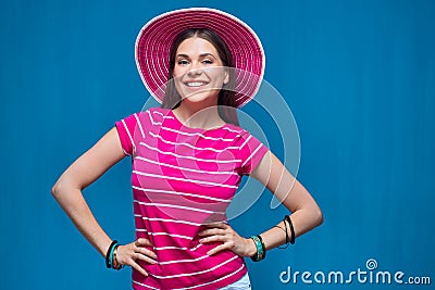 Smiling young woman wearing pink beach hat Stock Photo