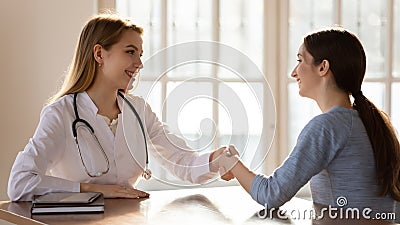 Female doctor shake hand get acquainted with patient Stock Photo