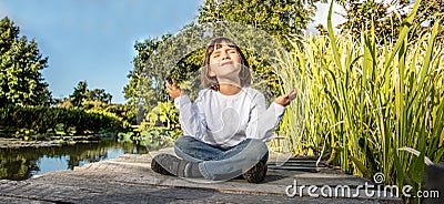 Smiling young 5-year old yoga child in lotus position Stock Photo