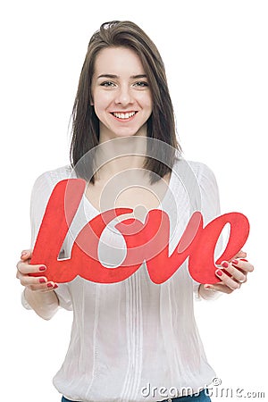 Smilling girl, holding title Love in her hands Stock Photo