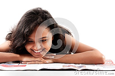Smilling indian teen reading newspaper Stock Photo