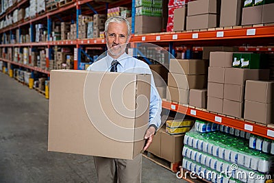 Smilng worker holding boxes Stock Photo