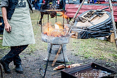 smith warms iron. Smith blows the coals and warm metal. Bellows. Stock Photo