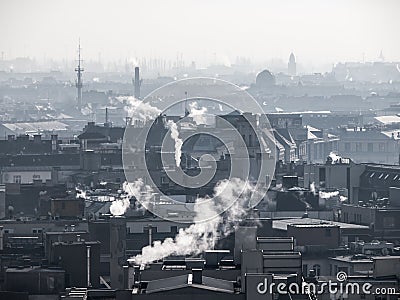 Smog - city air pollution. Unclear atmosphere polluted by smoke rising from the chimneys. Stock Photo