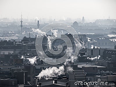 Smog - city air pollution. Unclear atmosphere polluted by smoke rising from the chimneys. Stock Photo