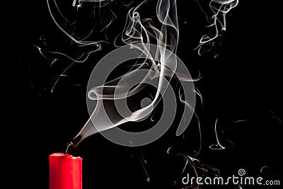 Smoke from blown out red candle Stock Photo