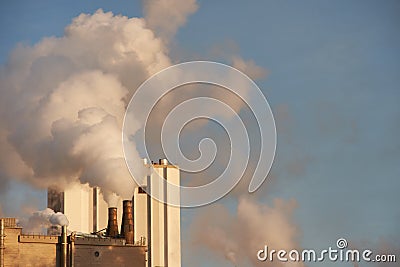 Smoke coming from factory chimneys. Plant for processing wood and cellulose Stock Photo