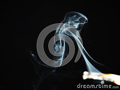 Smoke curls from a match. There is smoke without fire. Stock Photo