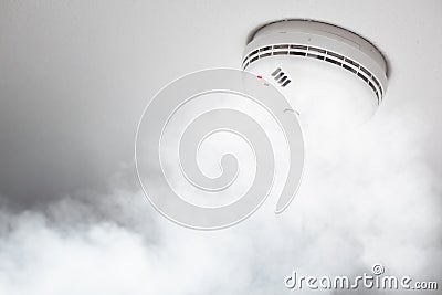 Smoke detector of fire alarm in action Stock Photo