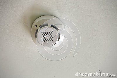 Smoke detector of fire alarm device on copy space background of white ceiling Stock Photo