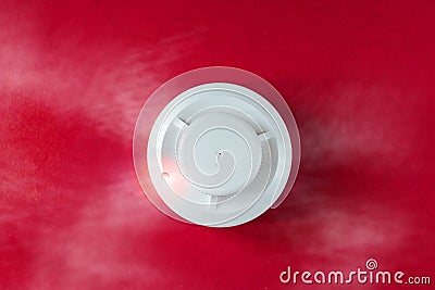 Smoke detector and fire detector on a red background.Fire Alarm flat lay Stock Photo