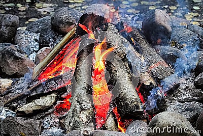 Smoke drifting out of a tepee campfire Stock Photo