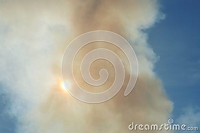 Smoke obscured sun. Smog and Sunny sky. Emissions of pollution into atmosphere. Smoke from fire. Hazardous industry. Toxic waste Stock Photo