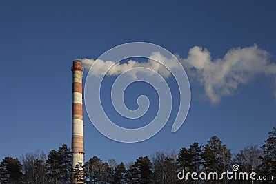 Smoke pipe CHP against the blue sky Stock Photo