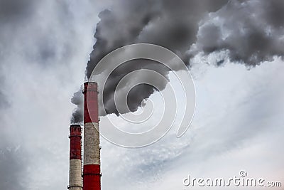 Smoke from the pipe. Smoking pipes in the sky industrial areas. black plumes of smoke coming out of industrial chimneys Stock Photo