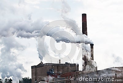 Smoke pollution through industrial chimneys Stock Photo