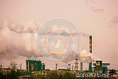 Smoke stacks in a working factory emitting steam, smog and air p Stock Photo