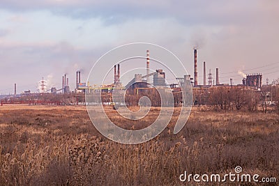 smoke stacks in a working factory emitting steam Stock Photo