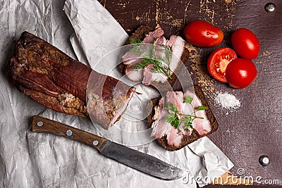 Smoked bacon with rye black bread and cuted tomatoes on the pack Stock Photo