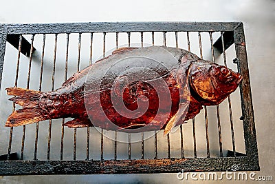 smoked carp on metal grill Stock Photo