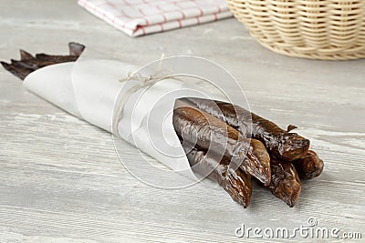 Smoked eels wrapped in paper Stock Photo