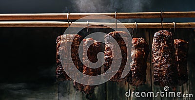 Smoked ham, bacon, pork in a smokehouse. Traditional method of smoking meat in smoke. banner, menu, recipe place for text Stock Photo