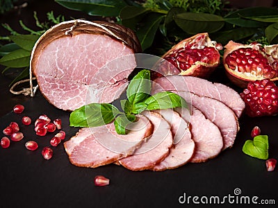 Smoked ham with herbs, fruits pomegranate Stock Photo