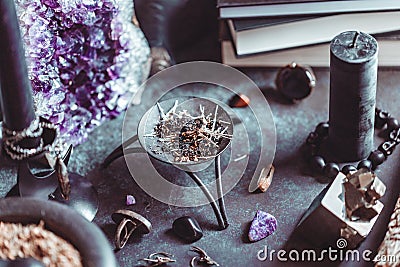 Smoked herbs on a witch`s altar for a magical ritual Stock Photo