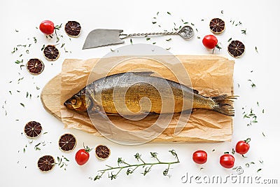 Smoked Omul fish with herbs and tomatoes Stock Photo