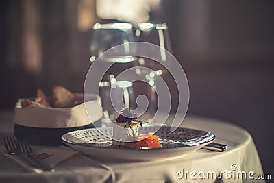 Smoked salmon with cheese, onion and herbs served on plate with glass of wine and toast, modern gastronomy Stock Photo