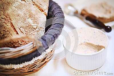 Smoked salmon cream spread in ramekin with bread loaf, appetizer Stock Photo