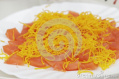 Smoked salmon cut into pieces decorated with angel hair Stock Photo