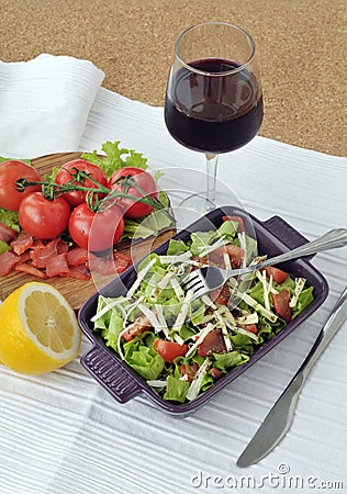 Smoked salmon salad with vegetables and glass of wine Stock Photo