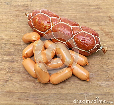 Smoked sausage and cooked sausage closeup on wooden background Stock Photo