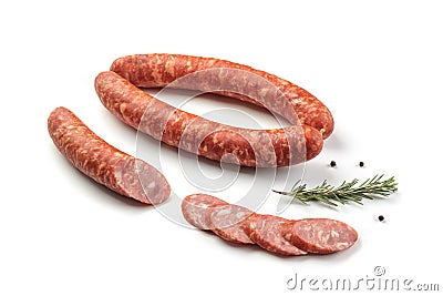 Smoked sausage salami with slices isolated on white background with herbal and pepper clipping path and full depth of field Stock Photo