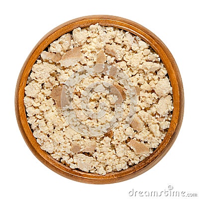 Smoked tofu, bean curd, crumbled by hand, in a wooden bowl Stock Photo